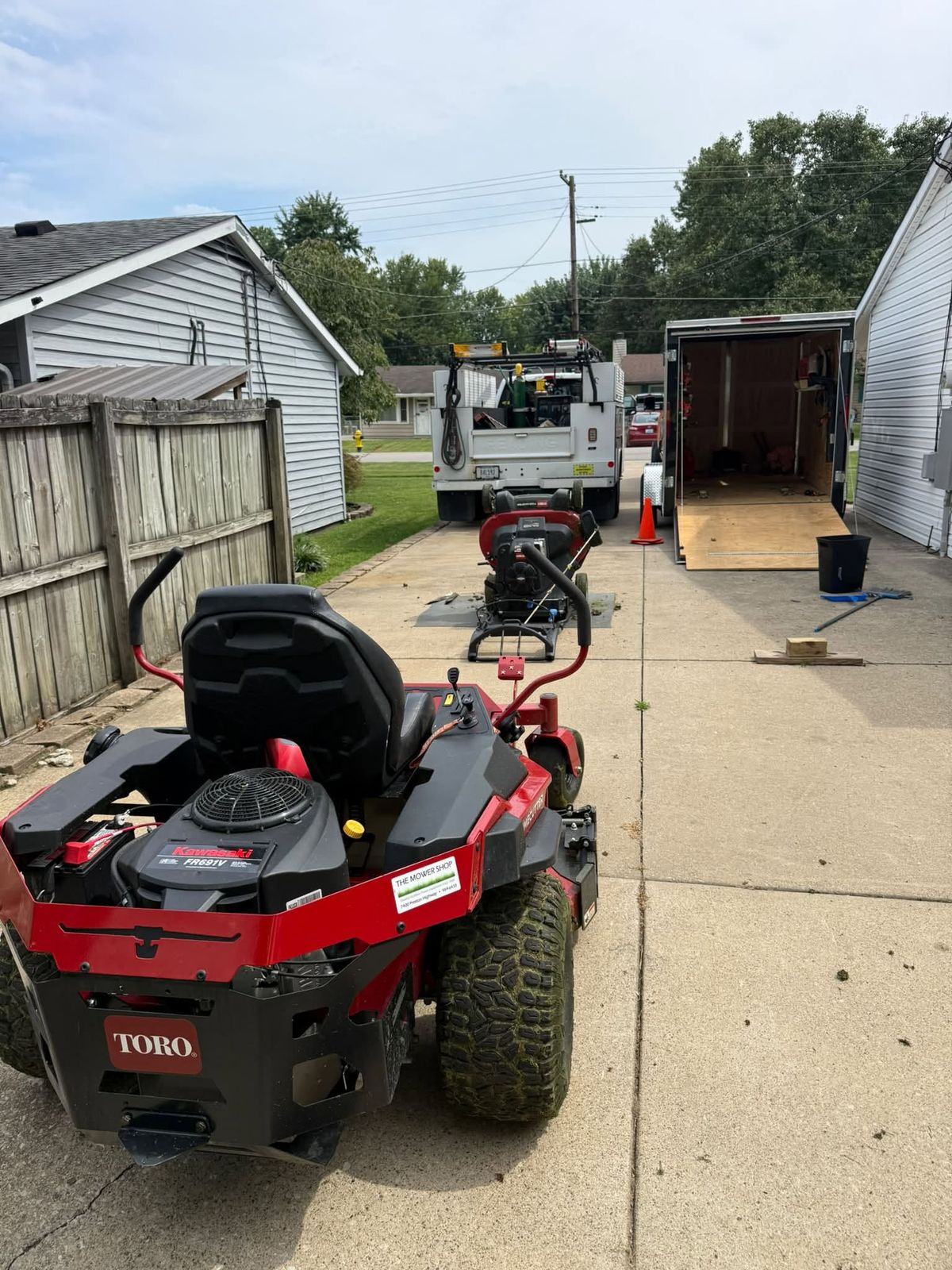 Both Toro mowers staged on a driveway by the service truck