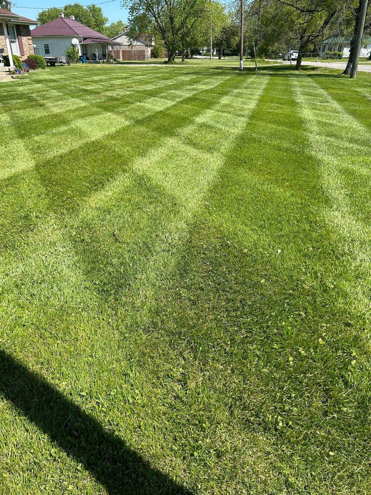 Light and dark checkerboard stripes cut into a lawn